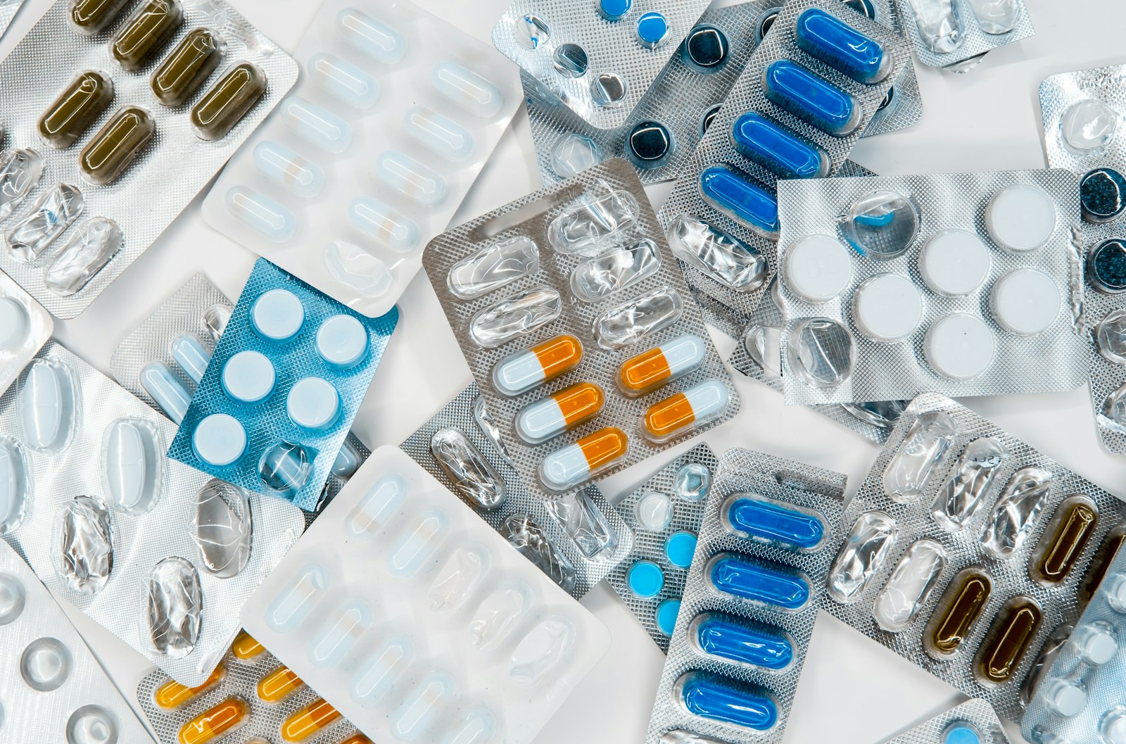 A pile of mixed pills on a flat surface
