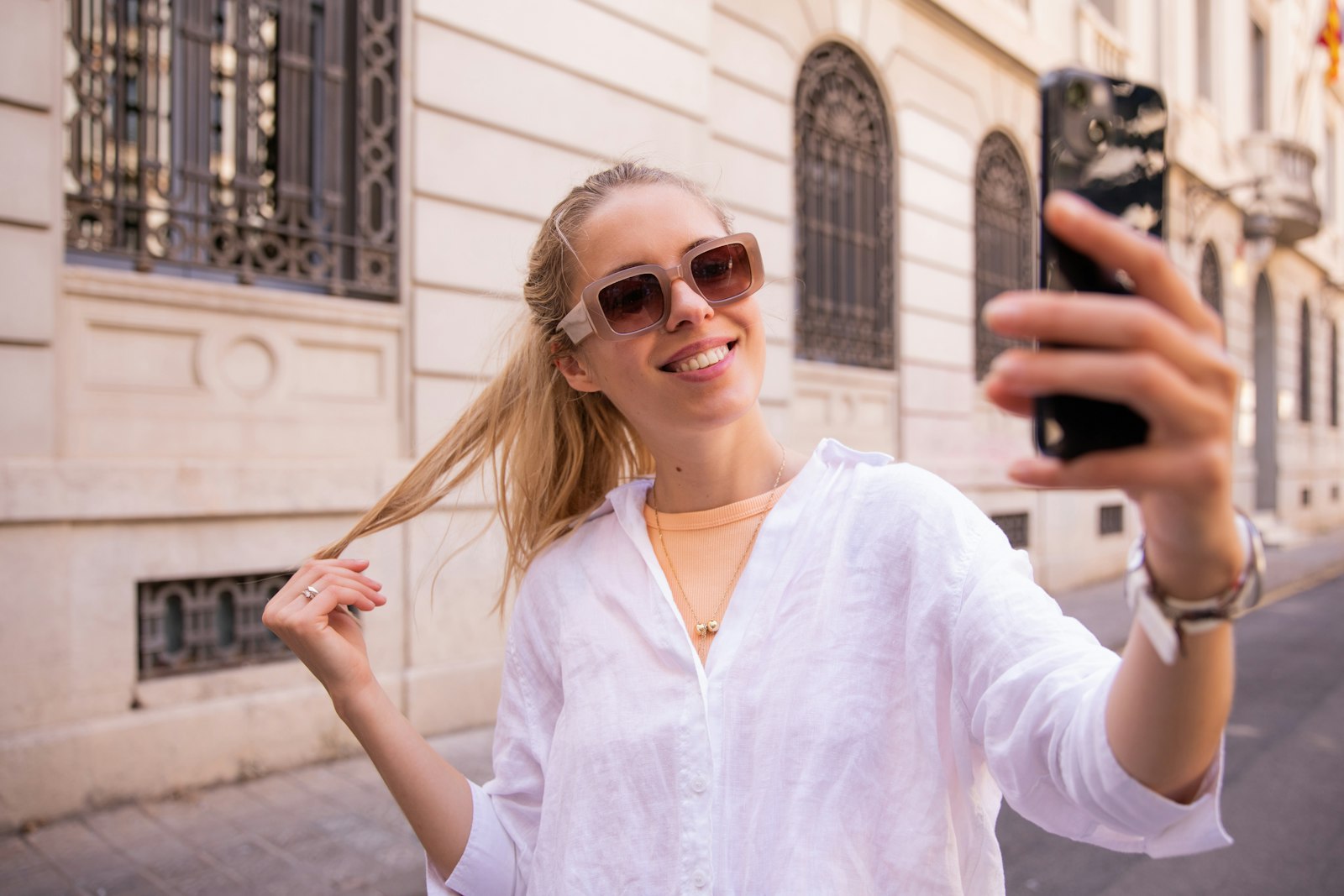 A young person holding up a phone in front of their face
