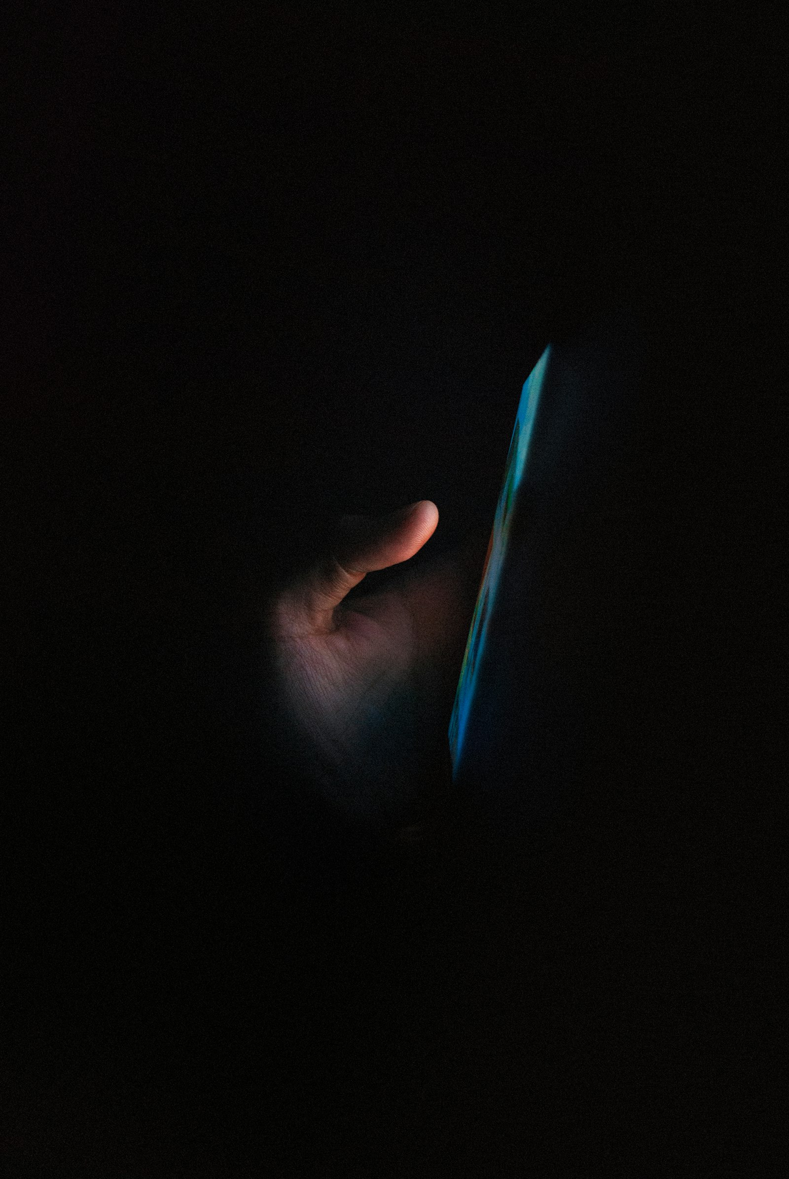 A glowing phone screen in a dark room