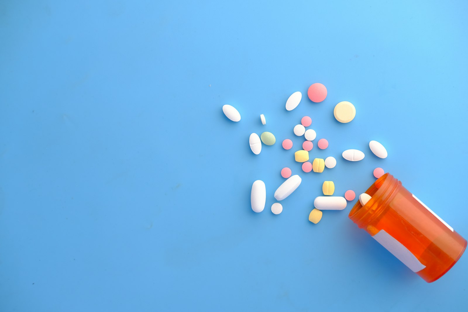 An orange pill on a clean surface