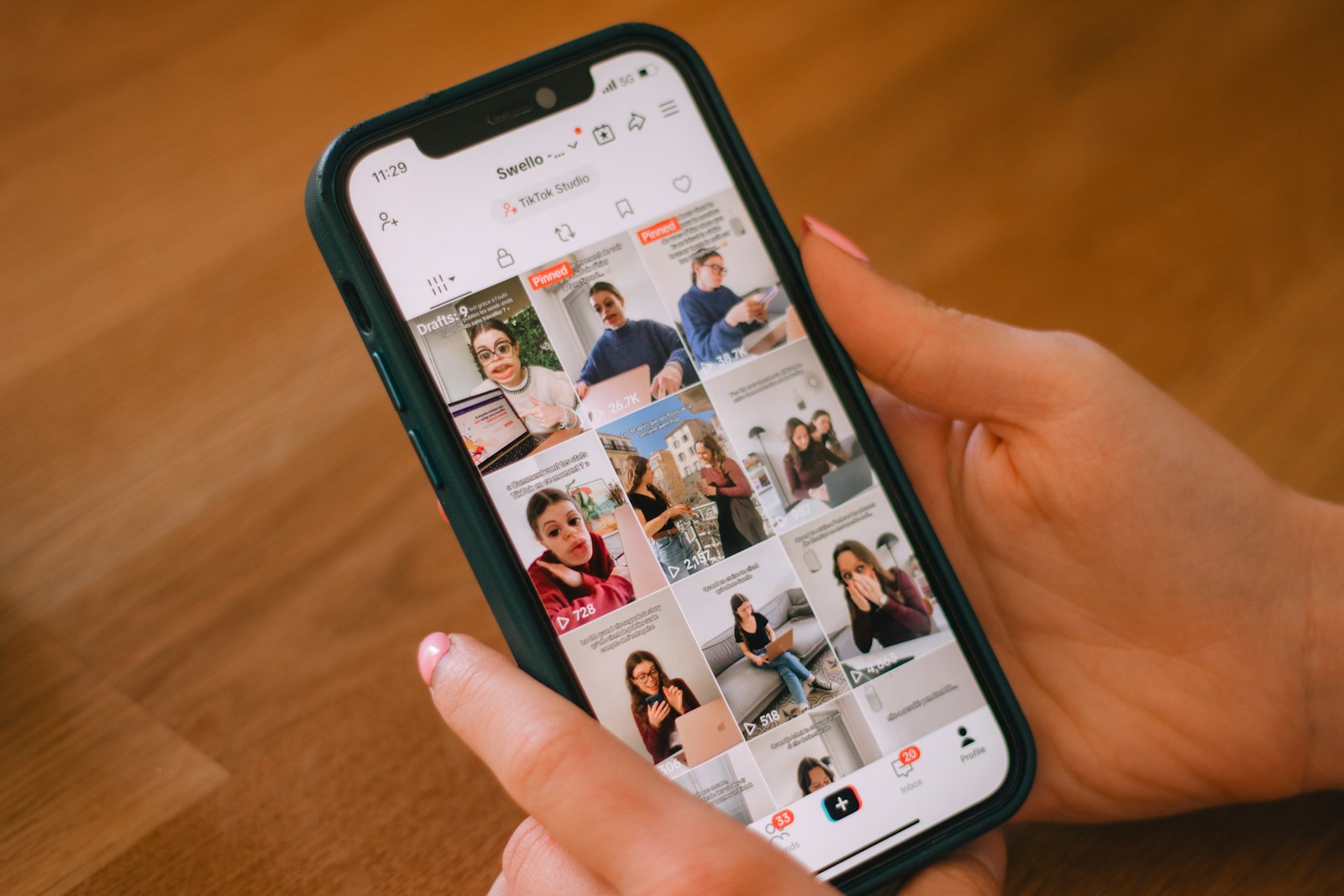 A hand scrolling through a social-media feed