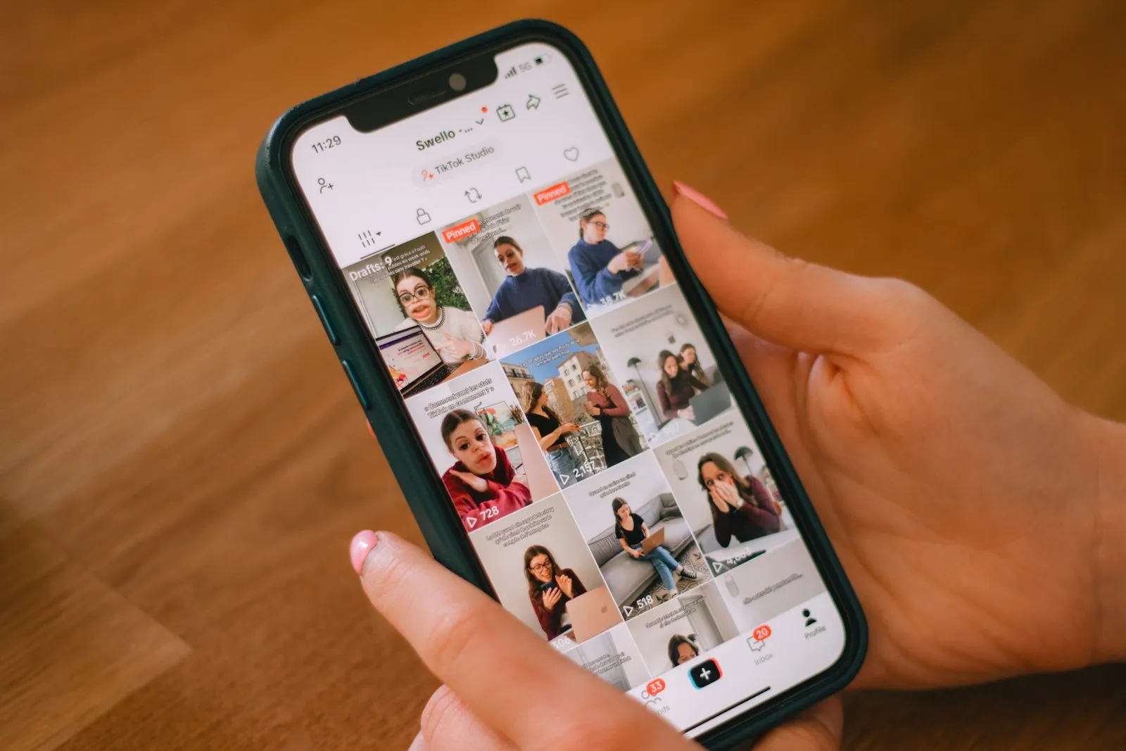 A hand scrolling through a social-media feed